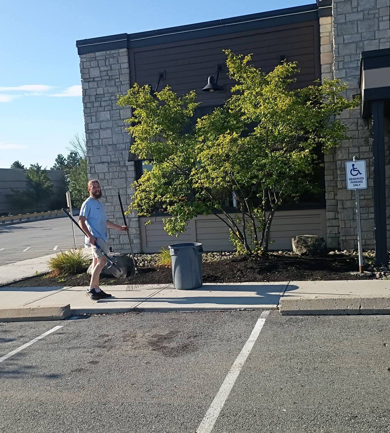 Crew working a commercial property beside a parking lot