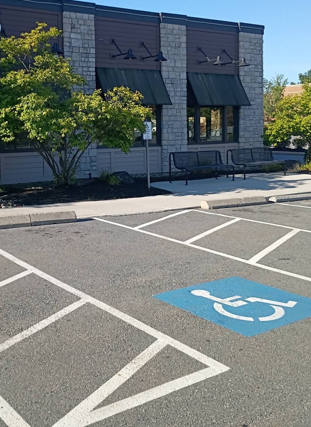Fresh mulch bed and benches outside a commercial building
