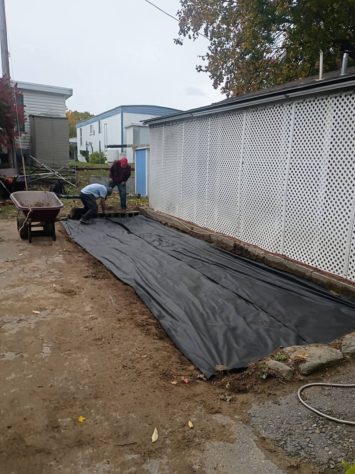 Fabric: landscape fabric going down along the fence